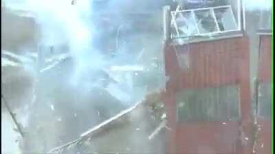 Idiot standing on top of a exploding building.