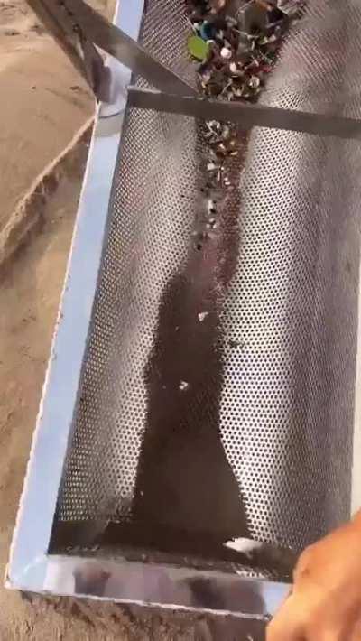 Cleaning up a beach by extracting small plastics from sand