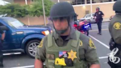 OC Sheriff deputy forgoing his name badge to wear a patch promoting the far right, racist Three-Percenter militia group at tonight’s protest in Costa Mesa.