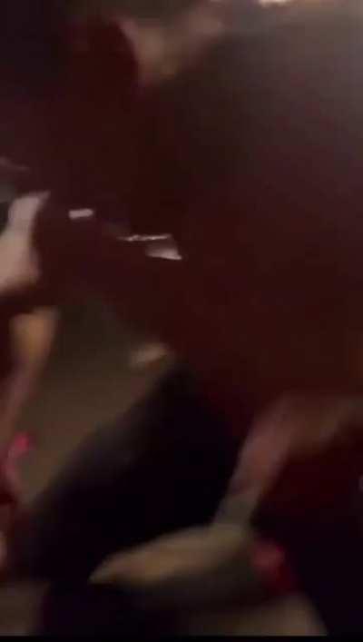 This guy throws a cup of urine on the crowd.