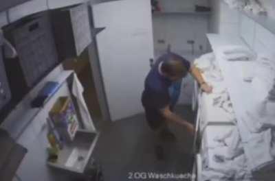 Man struggling against a dryer for dominion over his soul.