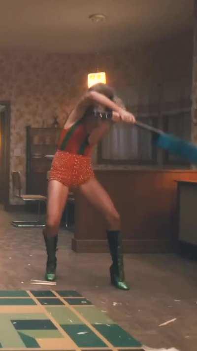 Showing off legs while smashing guitar (Anti-Hero music video)