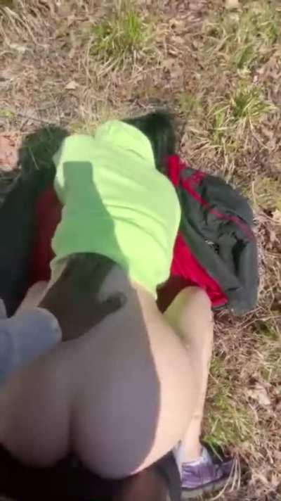 White girl stops to take a quick break during hiking trip with boyfriend