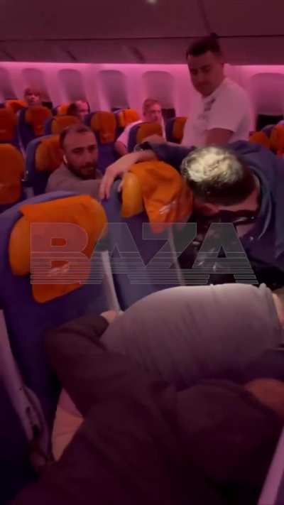 Drunk  passenger went wild mid-flight, screaming slurs, fighting the crew and trying to break a window