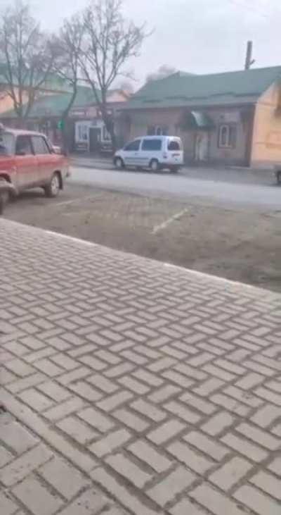 Looks as if Ukrainian civilian throws a petrol bomb at a Russian vehicle