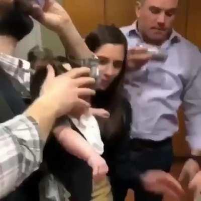 Shotgunning beer over babies head...