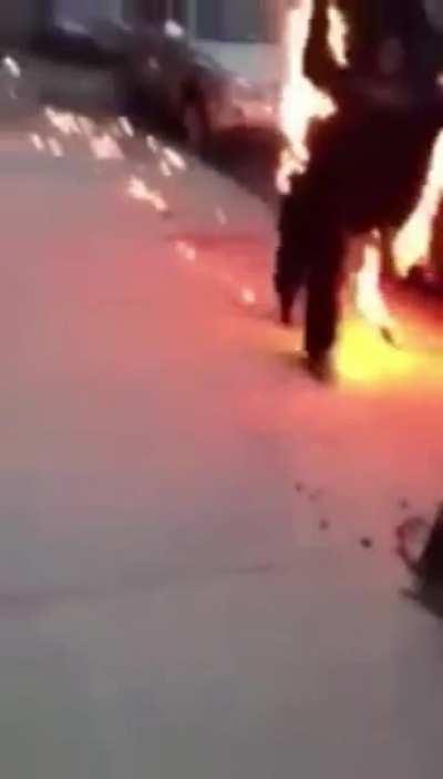 Homeless man casually engulfed in flames