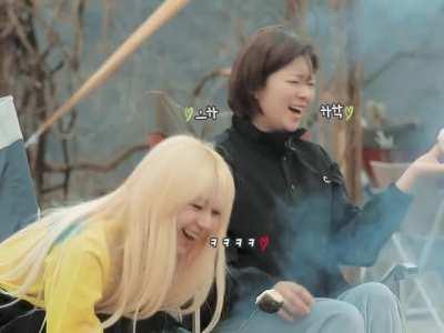 Chaeyoung setting a marshmallow on fire next to a slightly panicking Jeongyeon