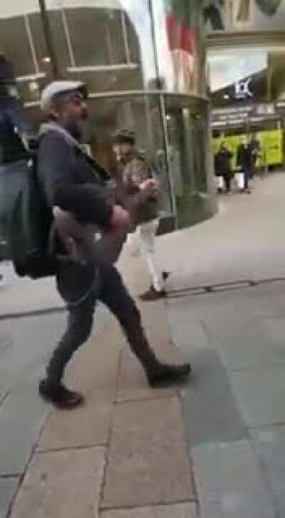 A busker performs The Auld Triangle through Dublin city