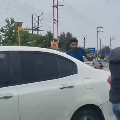 Two young men were thrown off their feet as a car hit them during a brawl in Ghaziabad, India yesterday. But the blows resumed as the college students got up