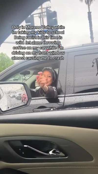 Racist lady gets confronted after throwing coffee on a car.
