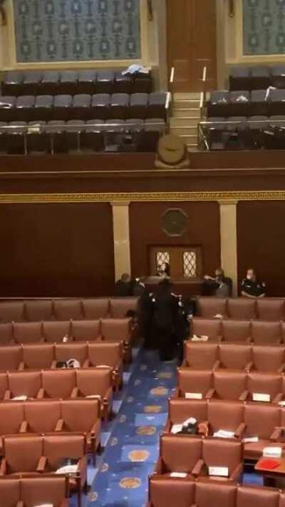 Capitol Police barricade the House Chamber with guns drawn after shots were fired through the door.