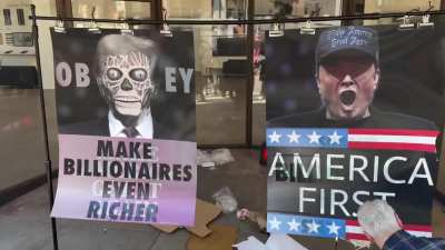 Brazil protest art is hung depicting Elon Musk and Trump as themselves and then transitioning into creatures demanding public obedience, from the move They Live