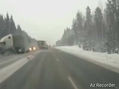 Car slips on ice road and gets crashed by a truck