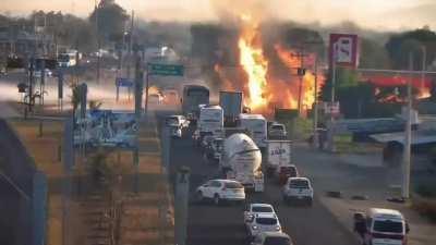 Gas truck leaking in a gas station blows up in Mexico, the first black smoke is from the truck at the front over revving and probably igniting the vapor.