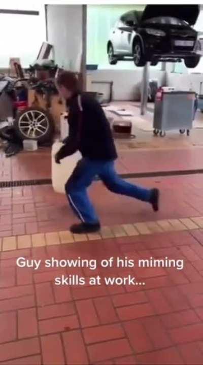 Man so good at miming that he made it seem as if the bin in his hand was stuck floating in one spot midair