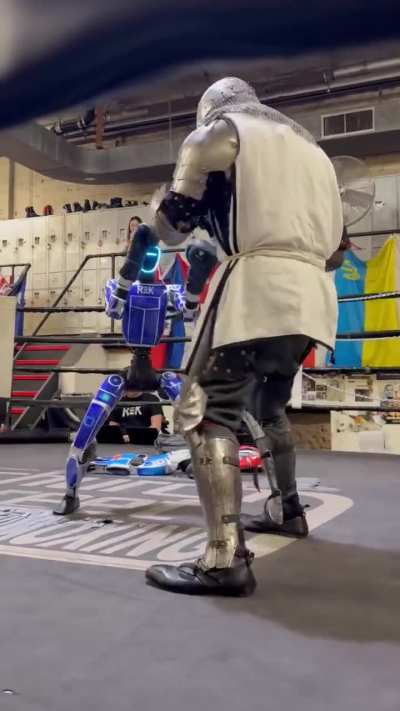 The video features a robot participating in a sparring match against a human knight. Behind-the-scenes footage for a robot fighting event that took place yesterday in New York City.
