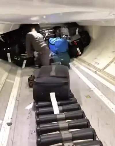 Luggages being neatly stacked to a plane compartment