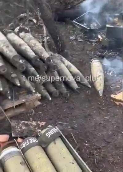 Brave Ukrainians pulling fused artillery shells out of the fire after their position was hit by Russians.