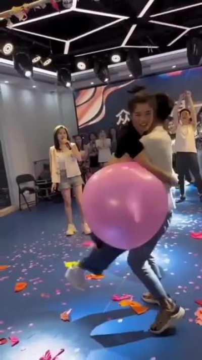 trying to pop a balloon