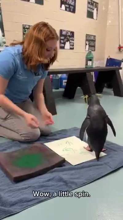Penguin paints a picture and is extremely pleased with herself.