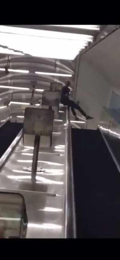 Sliding down an escalator handrail