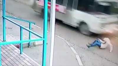 Woman trips in front of a bus and nearly gets her pumpkin squashed