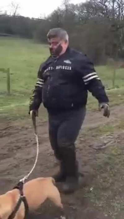 Walking out a powerful dog in muddy countryside