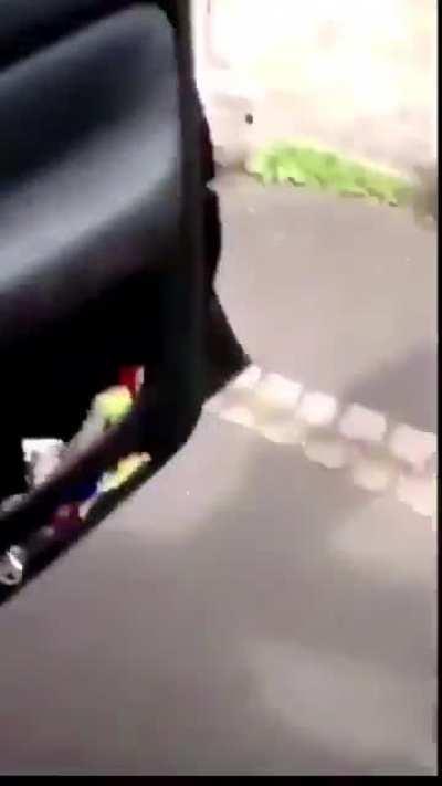 A men trying to go down the road gets mad.