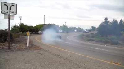 Professional stunt driver drifts on public highway flawlessly.