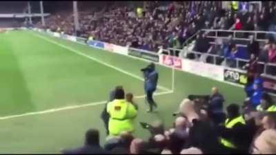 Home fan tries to fight away fan, gets dropped - England.