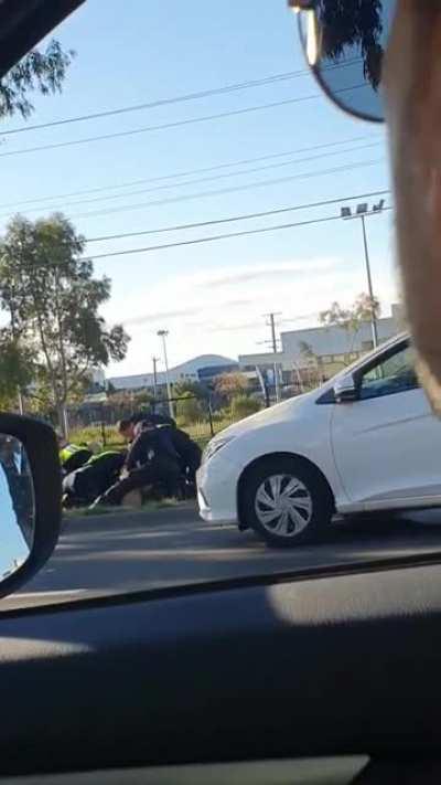 Police stomp the head of an escaped mental-health patient, today in Epping. (Graphic)