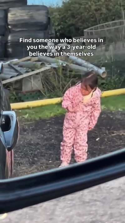 A little girl guides her father as he backs in his pickup to hook up a trailer