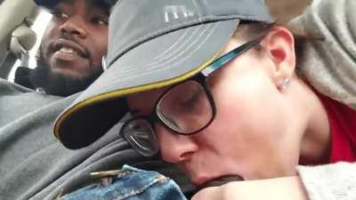 Female employee giving a quick suck in car to a black client