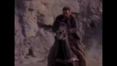 Harrison Ford having a problem with his hat on location. Indiana Jones and the Last Crusade. 1989