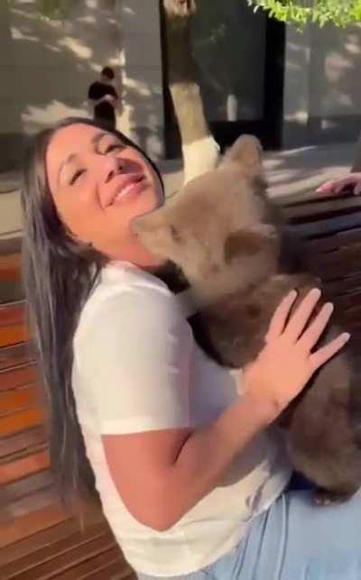 Hugging a bear cub