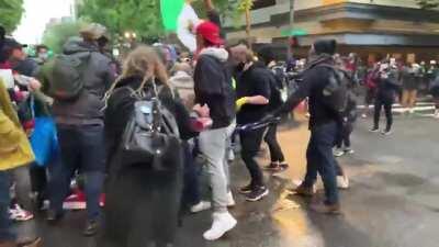 Protestors beating a man with American flag in Portland
