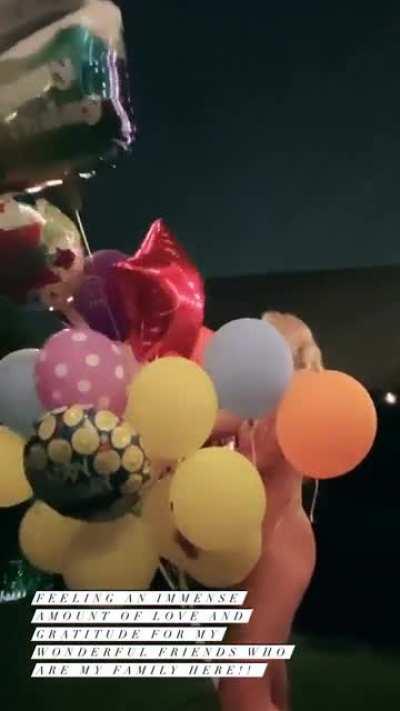 Naked behind balloons