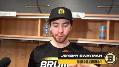 Linus Ullmark hand-feeds Jeremy Swayman a buffalo chicken wing during his post-game interview in Buffalo