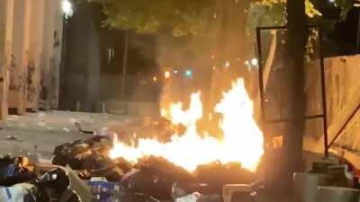 At the end of the night, riot ribs throws their garbage onto Portland Federal Courthouse property and sets it on fire.