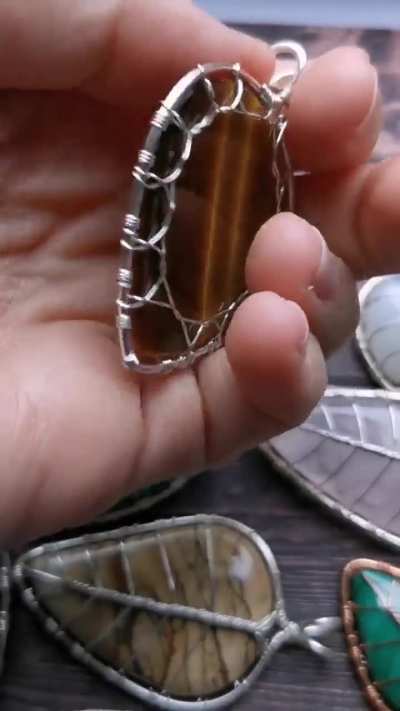 I made some elven leaf pendants with wire and gemstones.