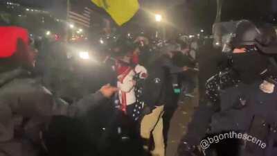 The crowd is pushed further back as police secure the U.S. Capitol and lawn out front shortly before the 6 pm DC curfew