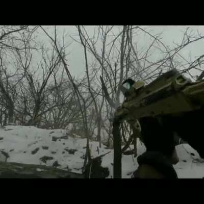Ukrainian fighter in trenches using PK machine gun, RPG