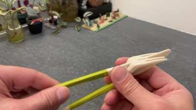 Fork and knife turning into chopsticks