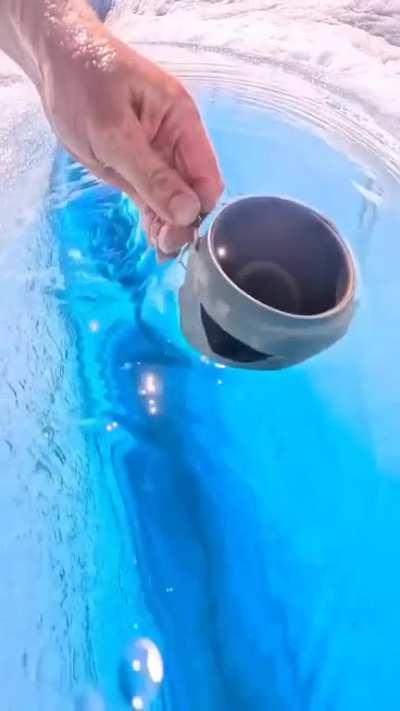 Taking a Sip of Water from a Glacial Chasm