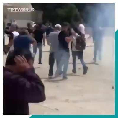 Israeli security forces were filmed hitting CNN producer Kareem Khader at the Al Aqsa Mosque compound in Jerusalem after Israeli security stormed in following Friday prayers. Israeli forces stormed the Al-Aqsa mosque and shot tear gas and rubber bullets a