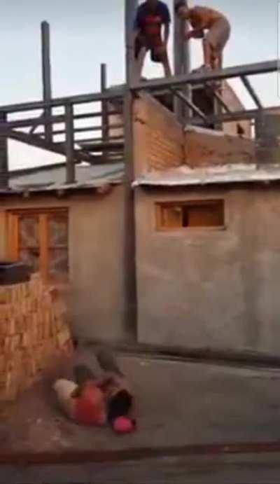 Attempting to catch a bag of cement thrown off a building