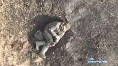 ua pov Ukrainian drone targets a Russian soldier that is bandaging himseld and smoking a cigarette. He appears to pass at the end.
