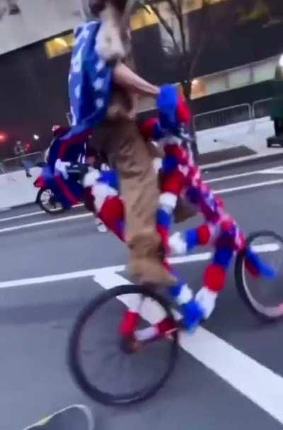 Qanon Shaman wipes out on a bike