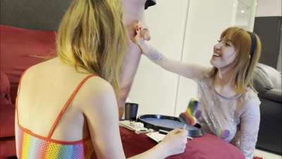 Festival girls in see through bodystockings and rave girl outfits give a lucky guy a handjob in a contest with throwing dice challenge